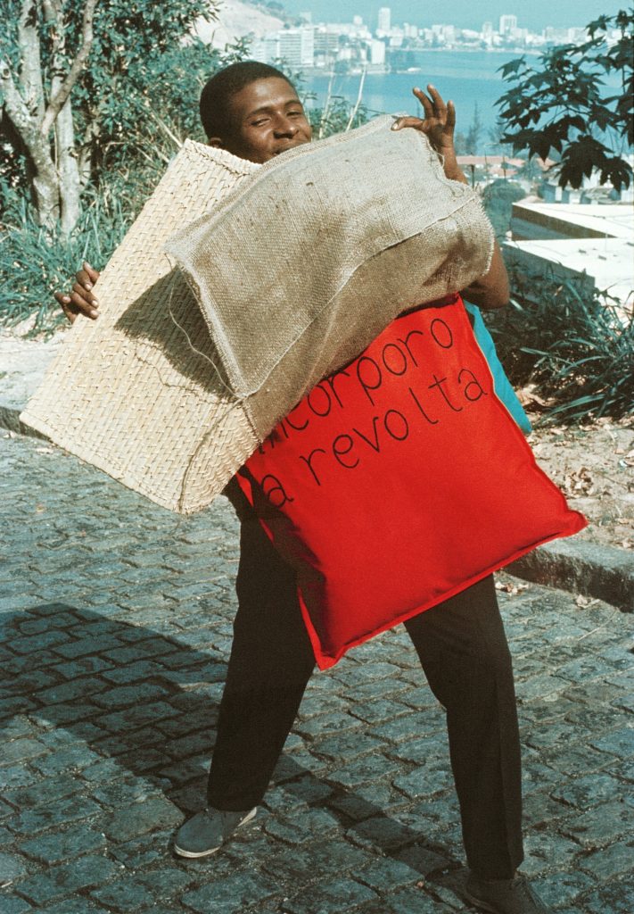 Nildo of Mangueira wearing “P15 Parangolé Cape 11, I Embody Revolt (P15 Parangolé capa 12, Eu incorporo a revolta, 1967),” ca. 1968, Facsimile of photograph, César and Claudio Oiticica, Rio de Janeiro